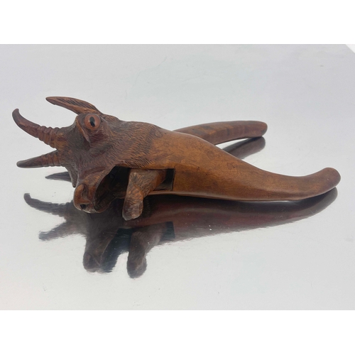 436 - A Black Forest carved wood nut cracker, modelled as a deer, the mouth opening, set with spherical gl... 