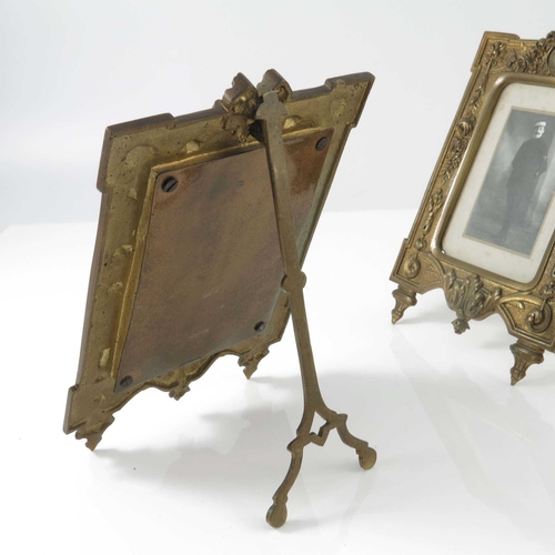 437 - A pair of Victorian gilt metal photograph frames, foliate design with ribbon surmount, splayed legs,... 