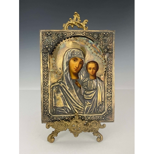 438 - A Russian Icon, Moscow 1873, encased in embossed and chased silver gilt cover depicting Madonna and ... 