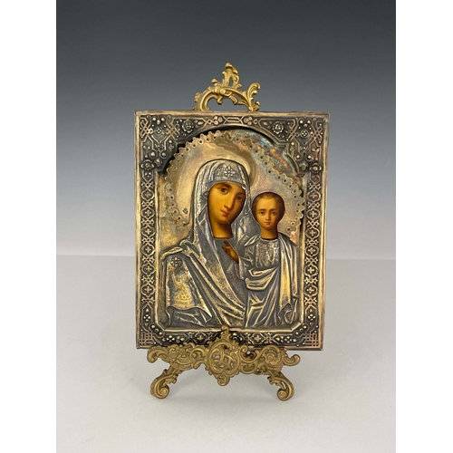 438 - A Russian Icon, Moscow 1873, encased in embossed and chased silver gilt cover depicting Madonna and ... 