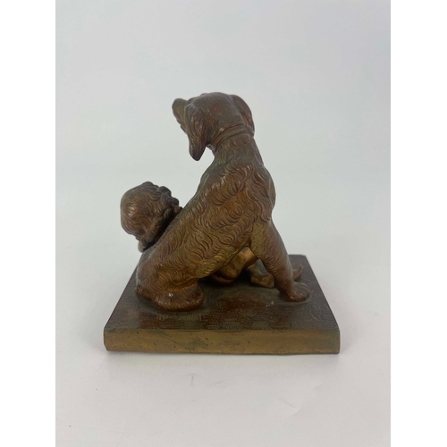 444 - A Victorian bronze figure group, modelled as a dog protecting a child, raised on rectangular wood an... 