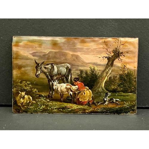 486 - A 19th century continental reverse painted glass plaque, pastoral landscape of a shepherdess milking... 