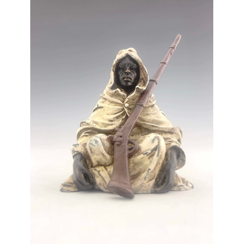 493 - Franz Bergman (Austrian, 1838-1894), a seated Arab holding a rifle, cold painted metal, stamped urn ... 