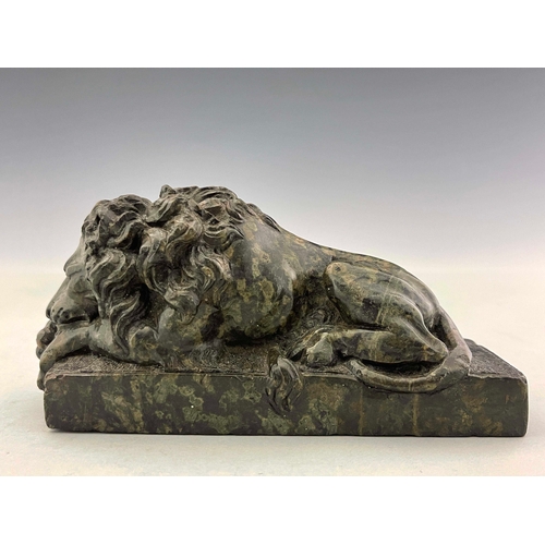 497 - An Italian green marble model of a Medici lion, late 19th Century, modelled recumbent on a plinth, 7... 