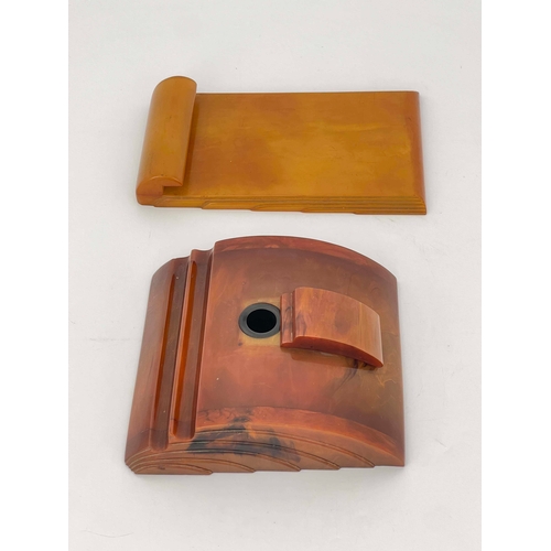 515 - An Art Deco Carvercraft Bakelite inkwell and notepad holder, amber effect, stepped and fanned design... 