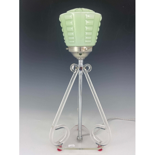 519 - An Art Deco lucite table lamp, three scroll end bracket supports, on triangular base