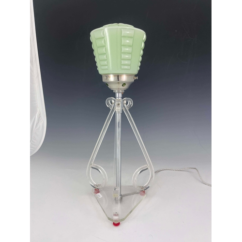 519 - An Art Deco lucite table lamp, three scroll end bracket supports, on triangular base