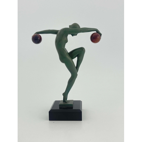 533 - Marcel Bouraine for Max Le Verrier, Danseuse au Boules, a green patinated art metal figure, circa 19... 