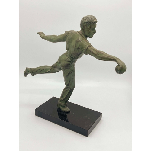 542 - Jean de Roncourt, Petanque Player, a green patinated art metal figure, circa 1930, modelled bowling ... 