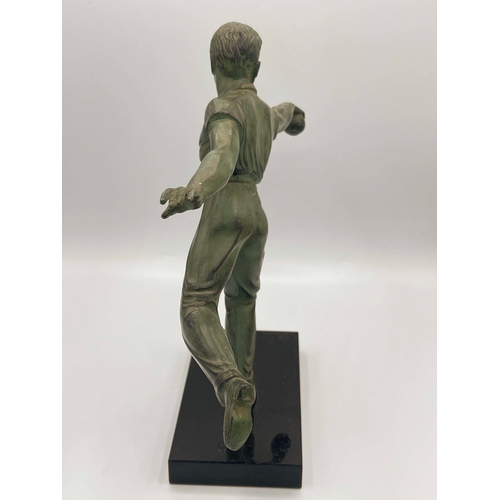 542 - Jean de Roncourt, Petanque Player, a green patinated art metal figure, circa 1930, modelled bowling ... 