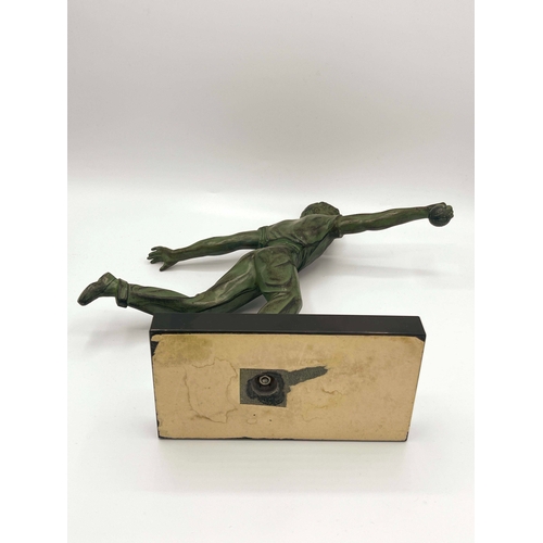 542 - Jean de Roncourt, Petanque Player, a green patinated art metal figure, circa 1930, modelled bowling ... 