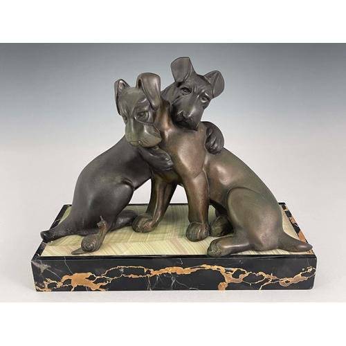 557 - Irenee Rochard, an Art Deco patinated art metal figure group, circa 1925, modelled as two dogs embra... 