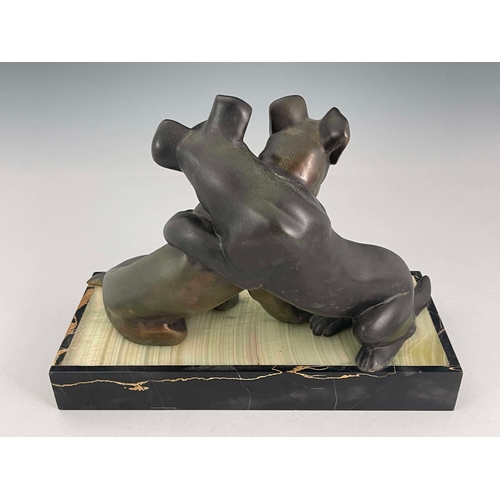 557 - Irenee Rochard, an Art Deco patinated art metal figure group, circa 1925, modelled as two dogs embra... 