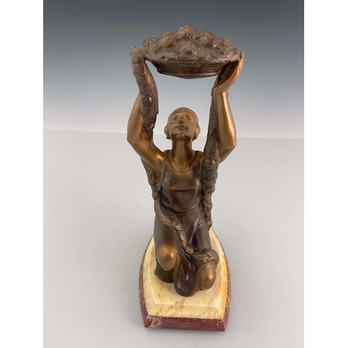 560 - A French Art Deco patinated art metal figure, circa 1925, modelled as a kneeling woman with floral g... 