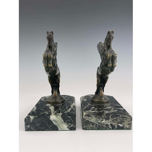 562 - Maurice Frecourt, a pair of Art Deco bronze Pegasus bookends, circa 1925, each modelled as the winge... 