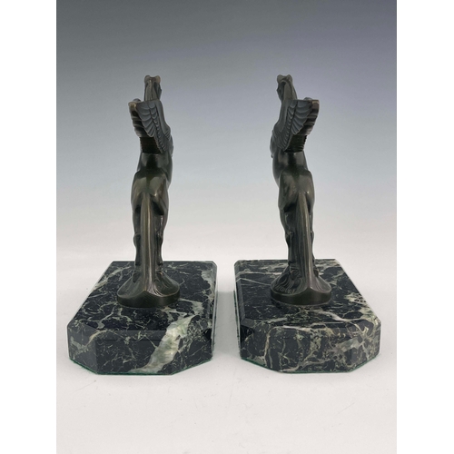 562 - Maurice Frecourt, a pair of Art Deco bronze Pegasus bookends, circa 1925, each modelled as the winge... 