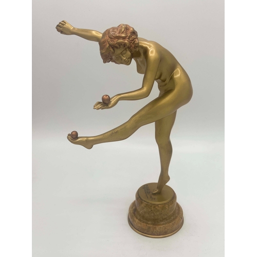 575 - Claire Colinet, Juggler, an Art Deco gilt bronze figure, circa 1925, modelled as a nude woman with t... 