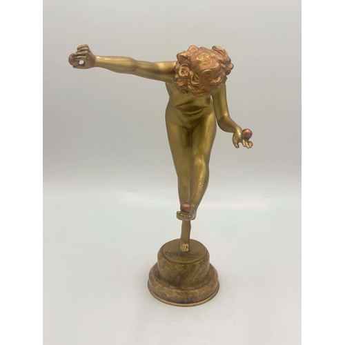 575 - Claire Colinet, Juggler, an Art Deco gilt bronze figure, circa 1925, modelled as a nude woman with t... 