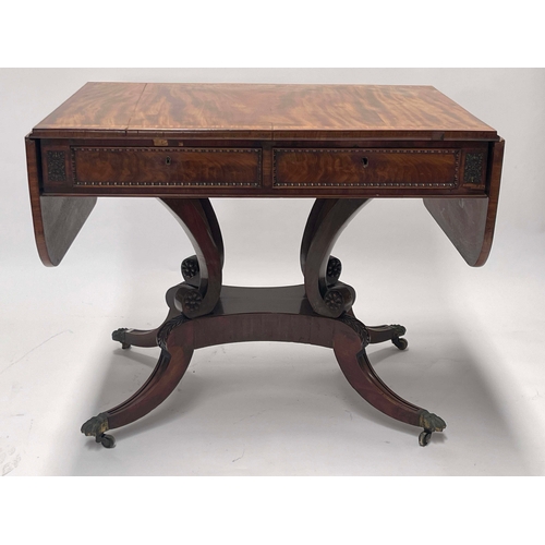 731 - A Regency flame mahogany sofa table, circa 1820, satinwood crossbanded top with end flaps, twin frie... 