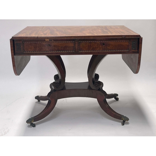 731 - A Regency flame mahogany sofa table, circa 1820, satinwood crossbanded top with end flaps, twin frie... 