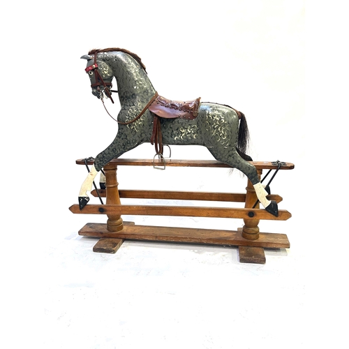 735 - A rocking horse, early 20th Century, dappled grey with tan leather saddle and tack, stained pine bas... 