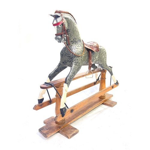 735 - A rocking horse, early 20th Century, dappled grey with tan leather saddle and tack, stained pine bas... 