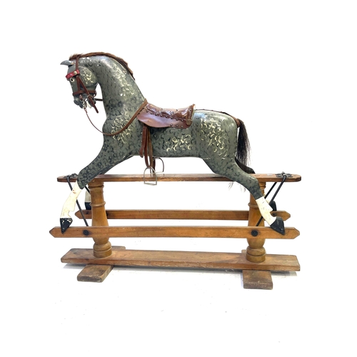 735 - A rocking horse, early 20th Century, dappled grey with tan leather saddle and tack, stained pine bas... 