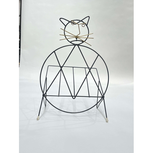 761 - Richard Galef for Ravenware,  a cat magazine rack, circa 1950s, black lacquered wire and brass facia... 