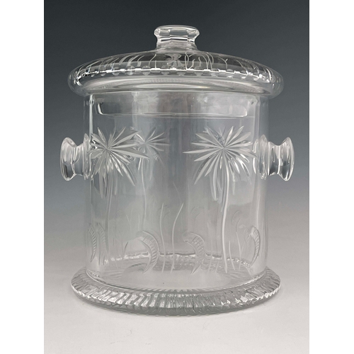 818 - William Yeoward, a clear cut glass ice bucket and cover, side handles, engraved palm tree and scroll... 