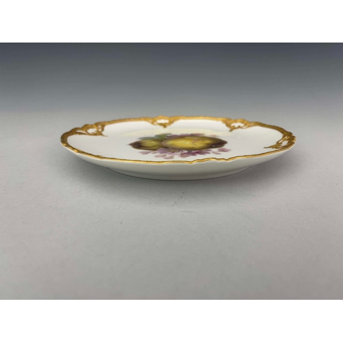 825 - A KPM fruit painted plate depicting quince within relief moulded border, together with a late 19th c... 