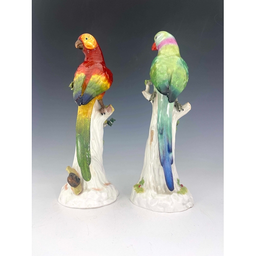 840 - A pair of Dresden porcelain figures of parrots on stumps, relied moulded with sprigs and insects, pa... 