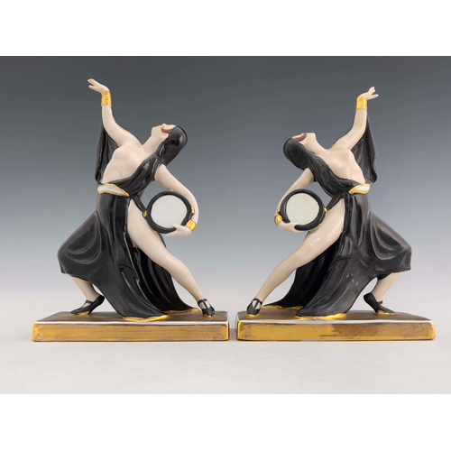 861 - Robj, a pair of Art Deco ceramic bookends, circa 1925, modelled as tambourine dancers, in black high... 