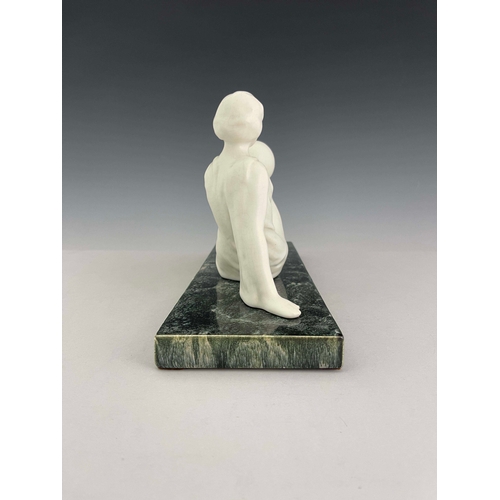 862 - Odyv, an Art Deco ceramic figure, circa 1930, modelled as a reclining woman holding a sphere, white ... 