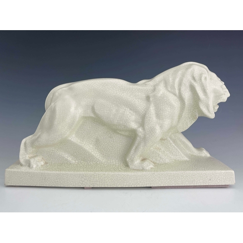 864 - LeJan, Lion Peugeot, an Art Deco ceramic figure, circa 1930, modelled as a striding lion, white craq... 