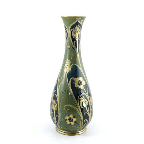 873 - William Moorcroft for James MacIntyre, a large green and gold Florian vase, circa 1903, slender balu... 