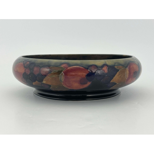 876 - William Moorcroft, a Pomegranate bowl, circa 1918, shallow footed form with inverted rim, impressed ... 