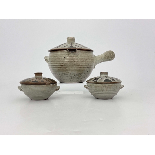 907 - David Leach, a studio pottery soup tureen and cover with two lidded bowls, decorated in wax resist w... 