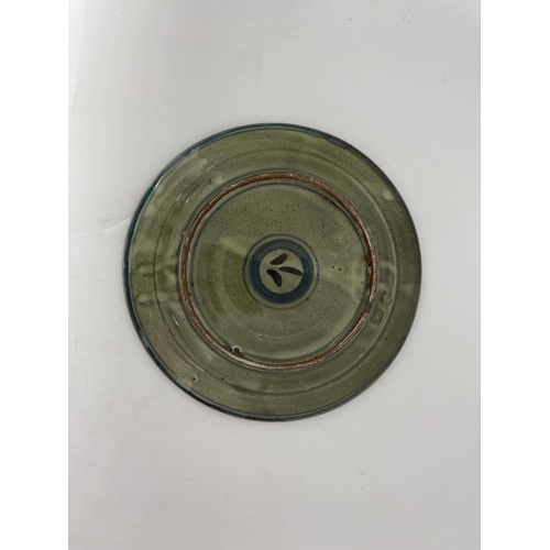 908 - Seth Cardew for Wenford Bridge, a studio pottery plate, celadon glaze and painted to the rim with al... 