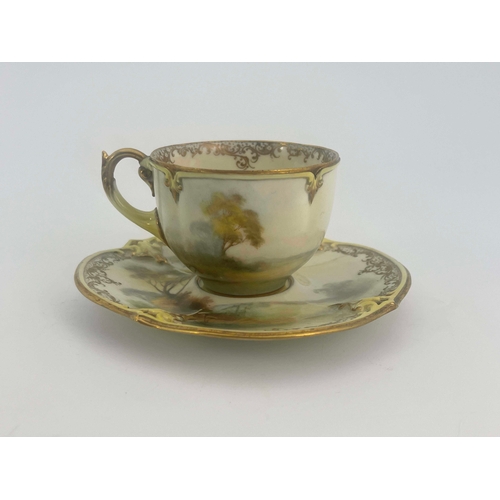 928 - Hadley's Worcester, a cabinet cup and saucer, lobed and painted with a pheasant in open countryside,... 