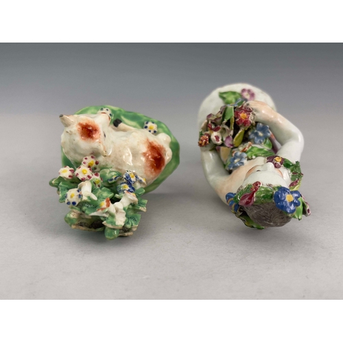 949 - Two English porcelain bocage figures, circa 1765, including a Derby ewe figure and a Bow floral putt... 