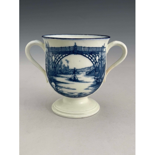 962 - A Caughley blue and white twin handled pedestal cup, circa 1782, Iron Bridge transfer design to one ... 