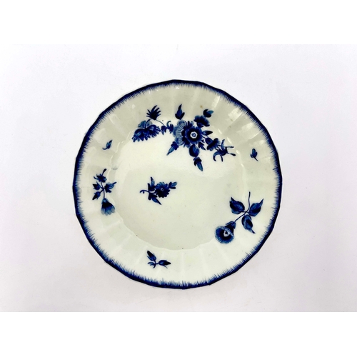 975 - A Worcester dry blue saucer, square mark, circa 1770, fluted and painted with floral sprays, within ... 