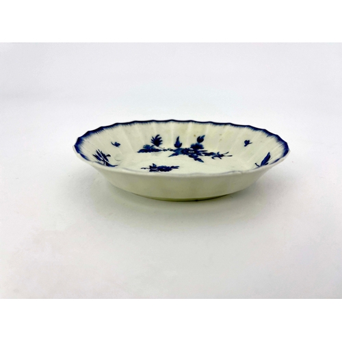 975 - A Worcester dry blue saucer, square mark, circa 1770, fluted and painted with floral sprays, within ... 