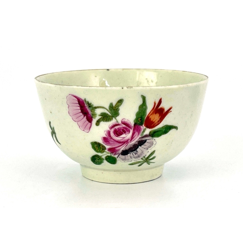 1027 - A Worcester polychrome tea bowl, circa 1760, painted with floral sprays, 7.5cm diameter