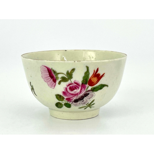 1027 - A Worcester polychrome tea bowl, circa 1760, painted with floral sprays, 7.5cm diameter