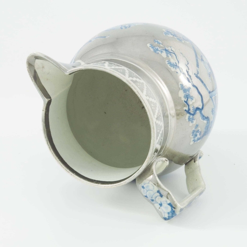 1085 - A silver lustre pearl ware pottery jug, globular form, circa 1815,  resist decorated with a blue and... 