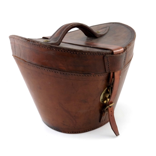 483 - Vintage Luggage, a tan leather hat box, late 19th Century, brass studded loop handle to the bowed hi... 