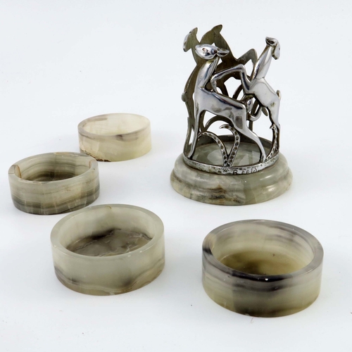 514 - An Art Deco Austrian chrome and onyx coaster set, housed in stand with leaping deer on onyx plinth, ... 