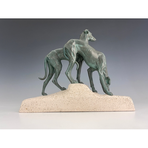 561 - Jules Edmond Masson, a patinated art metal figure group of two hounds, circa 1920, on naturalistic c... 