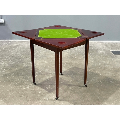 741 - An Edwardian mahogany, strung and crossbanded games table, circa 1910, retractable envelope top open... 